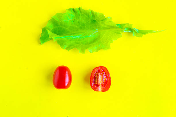 istock Sliced fresh cherry tomato on yellow background, minimal concept, summer time concept 1250939389