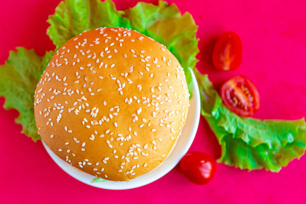 istock Fresh tasty hamburger on bright red background 1250939414