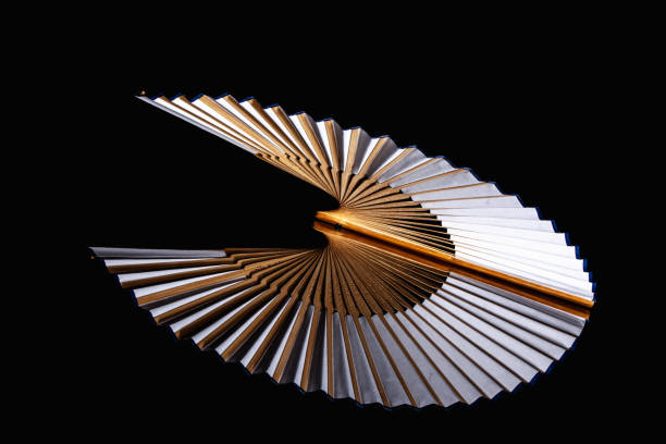 istock Bamboo open hand fan isolated on a black background. 1250941181