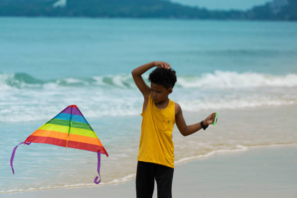 istock Young boy plays on the beach. 1250942751