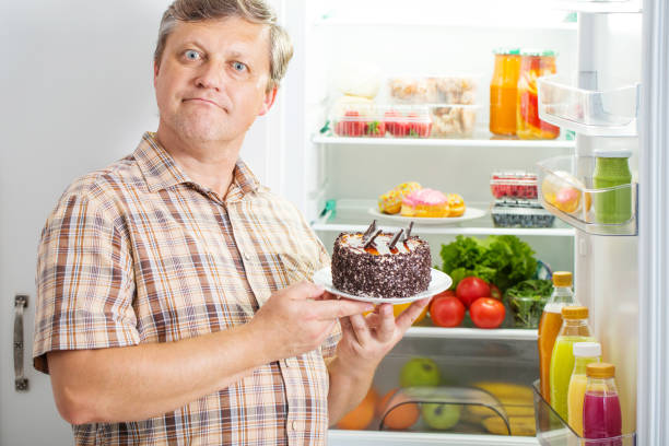 istock mature men at fridge  with food 1250947713