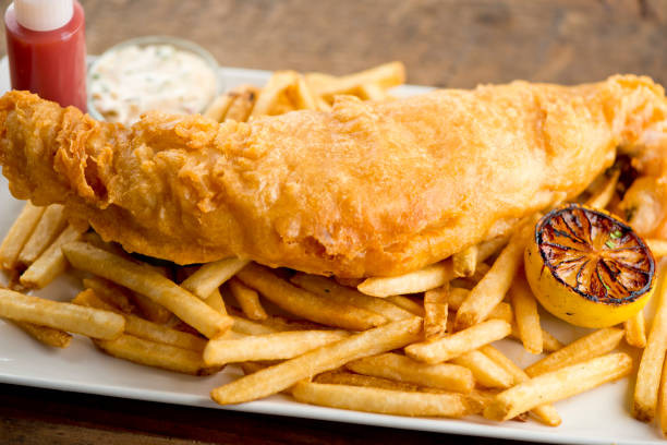 istock Fish and chips. Classic American pub or restaurant favorite, deep fried fish filets and crispy French fries served with ketchup and homemade tarter sauce. 1250949090