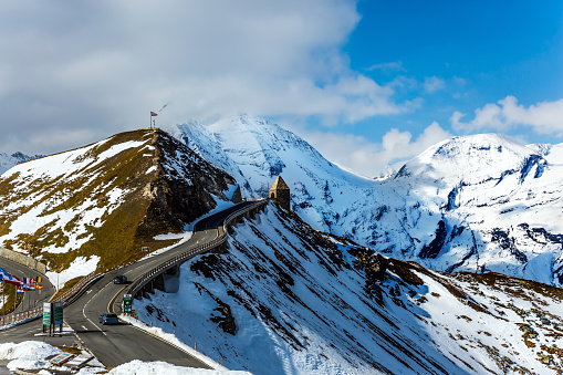 Austrian Alps. The snow on the mountainside began to melt. Dizzy turns of mountain serpentine. Gorgeous Grossglocknerstrasse. The concept of active, ecological and photo tourism