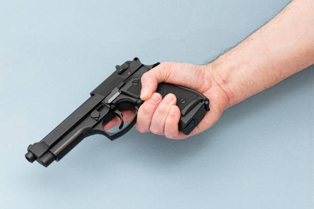 istock Men holding black pistol gun. 1250949327