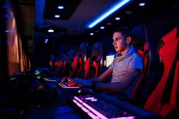 istock Focused young gamer playing video game at internet cafe, portrait. 1250949543
