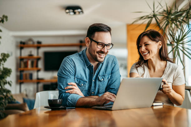 istock Happy couple at home, using laptop, portrait. 1250949614