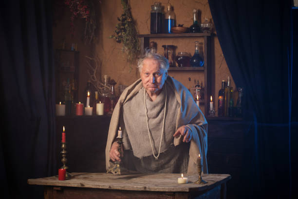 istock elderly alchemist monk  with candle 1250949793
