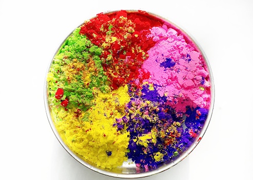 A plate of powder colors of red, yellow, green, blue and pink in the Indian festival of colors Holi
