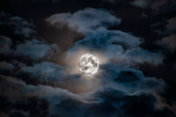 istock a bright full moon among the clouds 1250952703