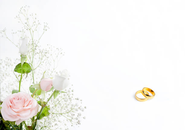 istock wedding rings of a rose with leaves 1250954647