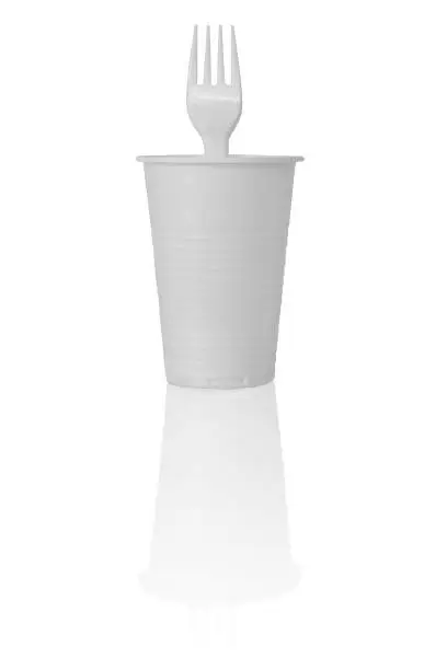 Plastic Cup with Fork in It. Isolated on White Background.