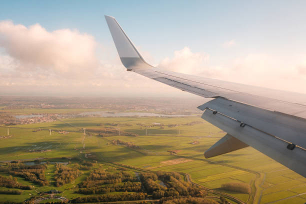 istock aiplane wing,  landscape aerial and blue sky 1250955544