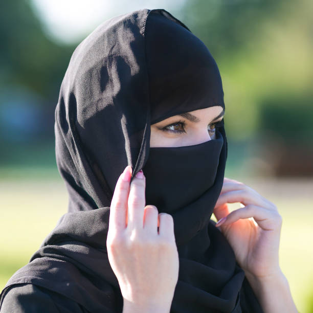 istock Arab woman in a black scarf on her head. 1250955982