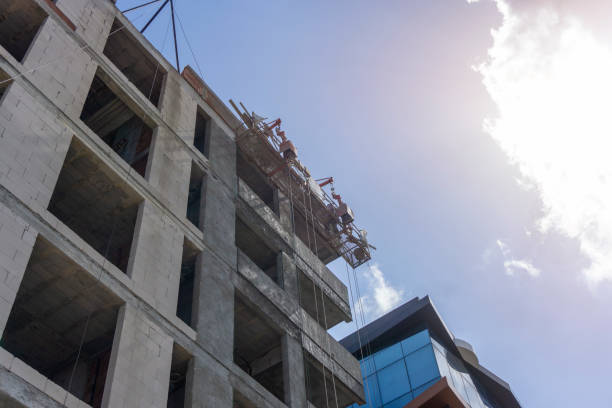 istock Construction workers plaster the facade of the house. Application Of Facade Plaster. Elevation of the building. Workers are plastering the facade of the building. 1250956042