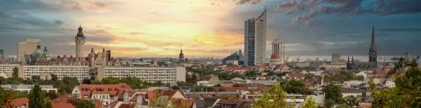 Panorama of the city of Leipzig, Germany, with tall buildings, town hall and churches with an interesting colored sky