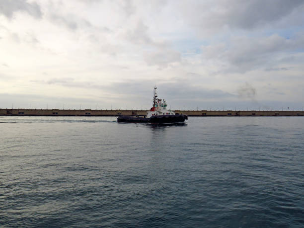Port practical service ship. Support service for maneuvers of large ships. Sailing and ships background.