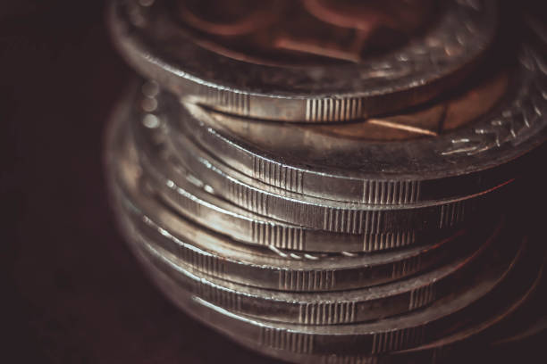 istock Coins stacked on each other in different positions on dark background. Money concept. Closeup. Money and saving concept. Success, wealth and poverty, poorness concept. Business Growth concept. 1250961049