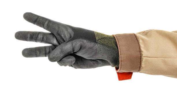 istock Male hand in black protective glove and brown uniform doing number three gesture isolated on white background 1250961992