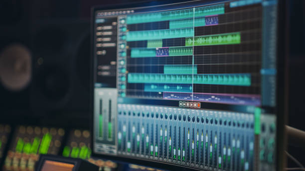 istock Modern Music Recording Studio Equipment: Computer Screen Showing User Interface of DAW Digital Audio Workstation Software with Track Song Playing. Sound and Music Recording and Editing Application 1250963301