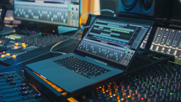 istock Modern Music Record Studio Control Desk with Laptop Screen Showing User Interface of Digital Audio Workstation Software. Equalizer, Mixer and Professional Equipment. Faders, Sliders. Record. Close-up 1250963436