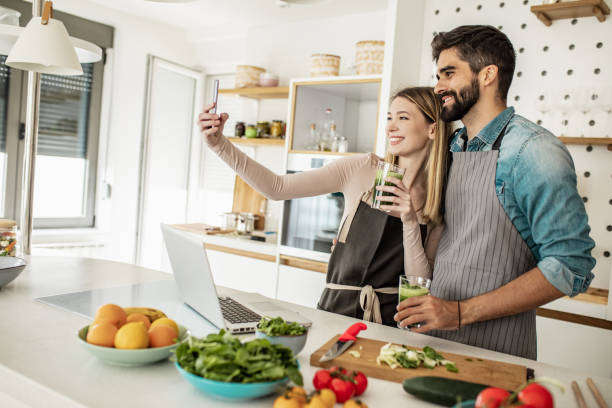 istock Young couple is preparing healthy meal and taking selfie 1250964127