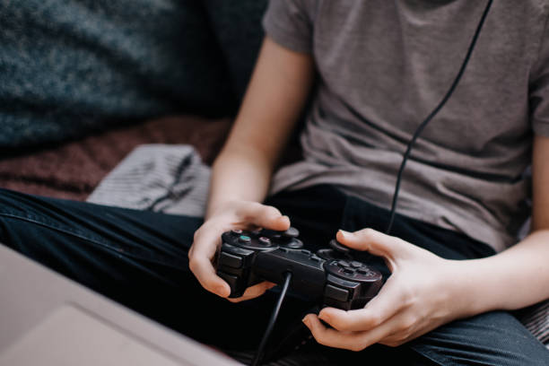istock The boy using a laptop for playing online games. The guy is playing on the console. 1250964215