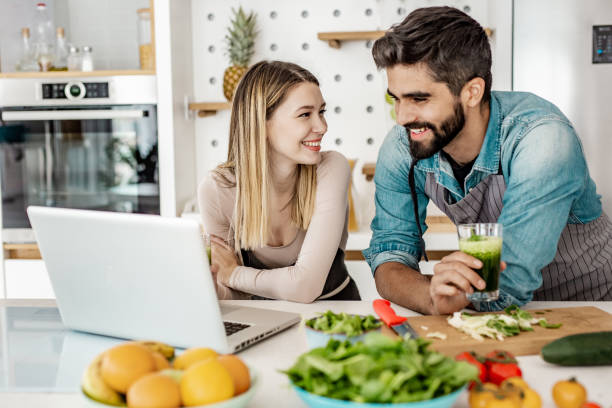 istock Young couple is looking for recipes online 1250964393