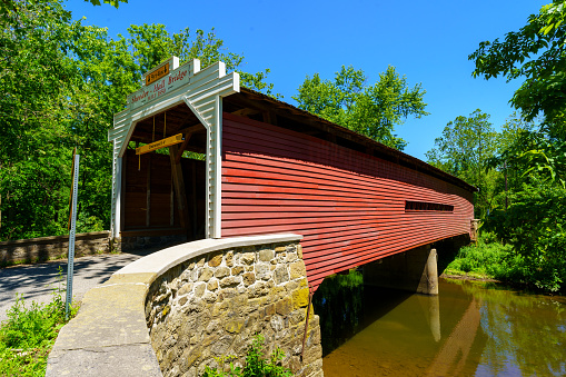 Phoenixville, PA, USA - June 14, 2020: The Sheeder-Hall  Bridge is a 100-foot-long covered bridge in Chester County. It crosses French Creek and was constructed in 1850.