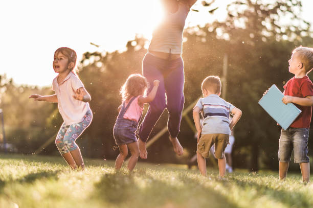 istock Happy kids jumping in nature 1250966727