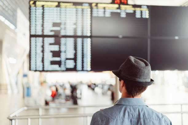 istock Tourist at airport checking the arrival departure board 1250967241