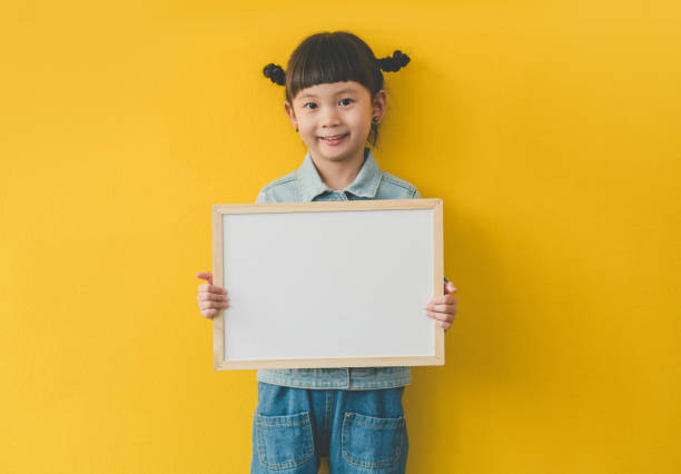 귀여운 아시아의 어린 소녀 와 흰색 이빨 들고 에 손 와 빈 화이트 보드 - whiteboard placard blank holding 뉴스 사진 이미지