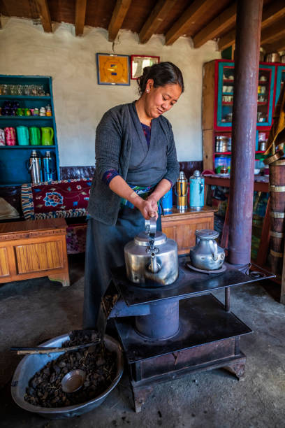 istock Tibetan woman is boiling water, Upper Mustang, Nepal 1250969900
