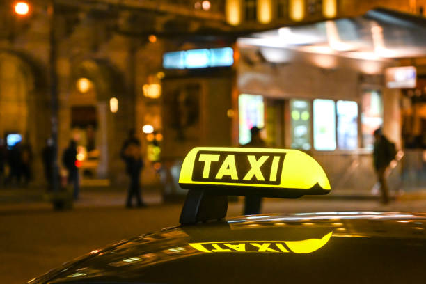 istock Taxi sign on car illuminated at night 1250969903