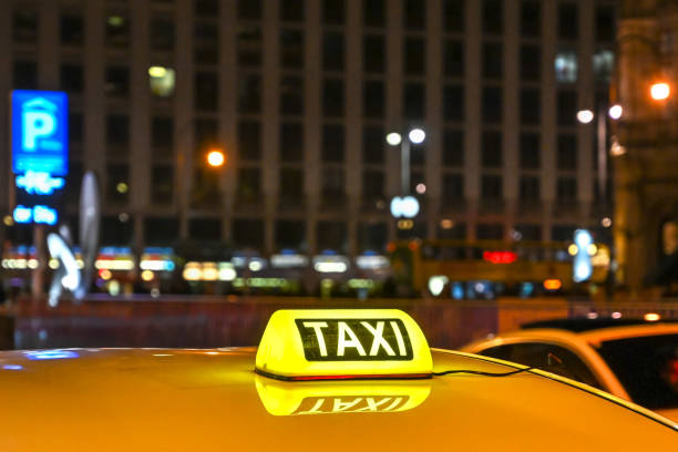 istock Taxi sign on car illuminated at night 1250969905