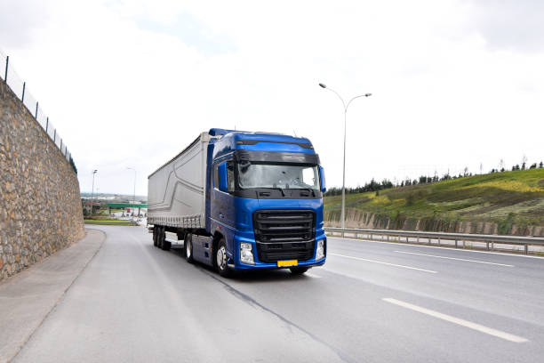 istock Truck passing next to highway wall 1250971264