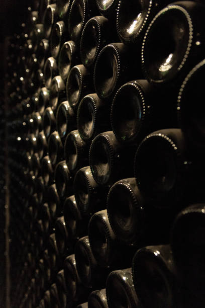 istock Close up image of wine bottles stacked in a cellar in winery 1250972078