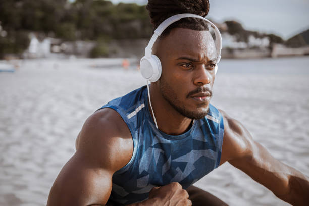 istock African athlete stretching outdoor at the beach 1250972797