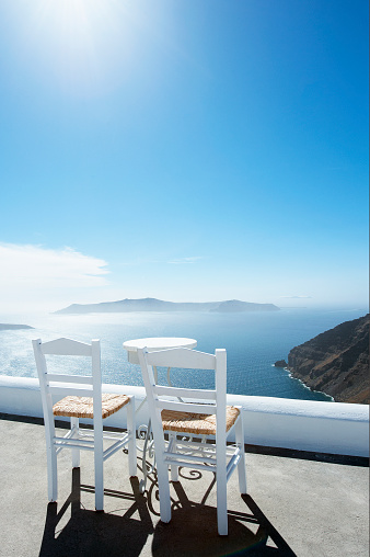 view of Santorini with two white chairs in front