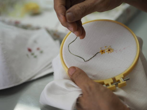 手の女性刺繍花シンプルステッチで手のステッチの花手作りアート - thread tailor art sewing ストックフォトと画像