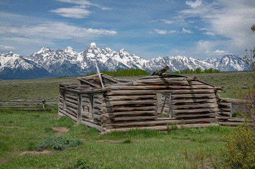 Log cabin with Grand Teton National Park mountains in the background