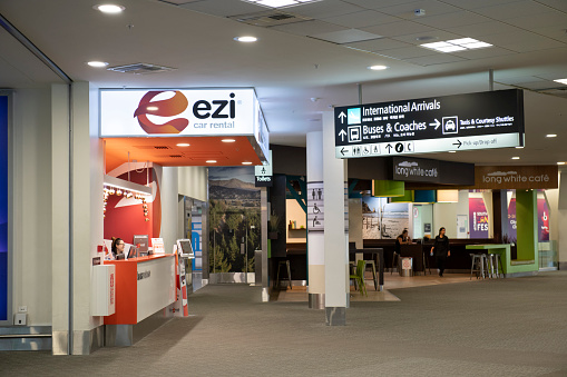 Christchurch, New Zealand - December 30, 2018. People at Ezi car rental counter and Long White Cafe in the terminal of Christchurch Airport, Christchurch, New Zealand.