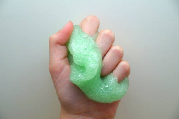 istock green slime in a child's hand close up 1250977996