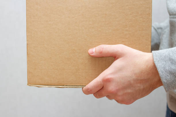 istock A young courier in a hoodie and jeans delivered a parcel 1250979976