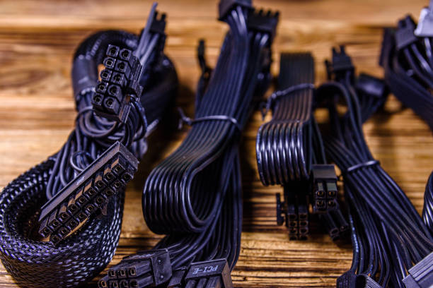 istock Set of computer psu cables on a wooden background 1250980743