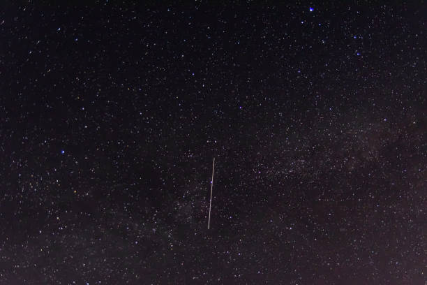 istock Background of the night sky with many stars. Satellite trajectory 1250981009