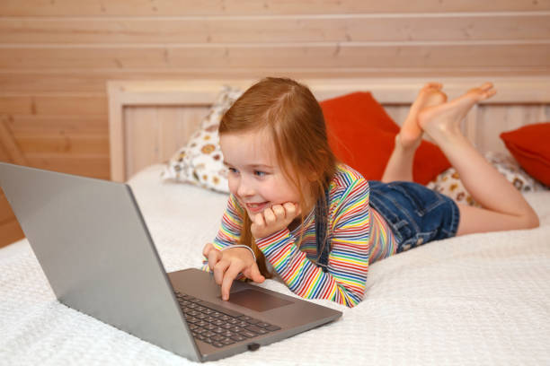 istock A little girl looks at the computer with different emotions 1250983287