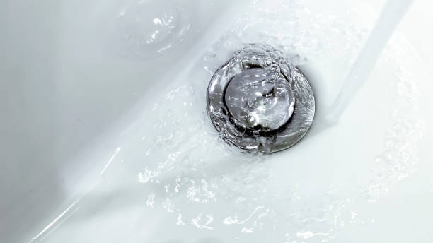 istock water falling from a tap into a white ceramic sink 1250983655