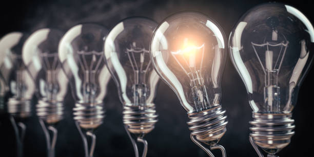 istock Row of light bulb with a one glowing. Idea and innovation concept. 1250984376