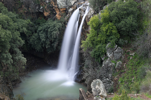 High waterfall and greenery all around. Long exposure photography. High quality photo