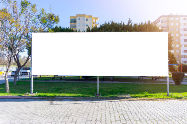 White canvas billboard on in the street. Billboard, Poster, Road Sign, Street Light, Banner - Sign billboard posting stock pictures, royalty-free photos & images